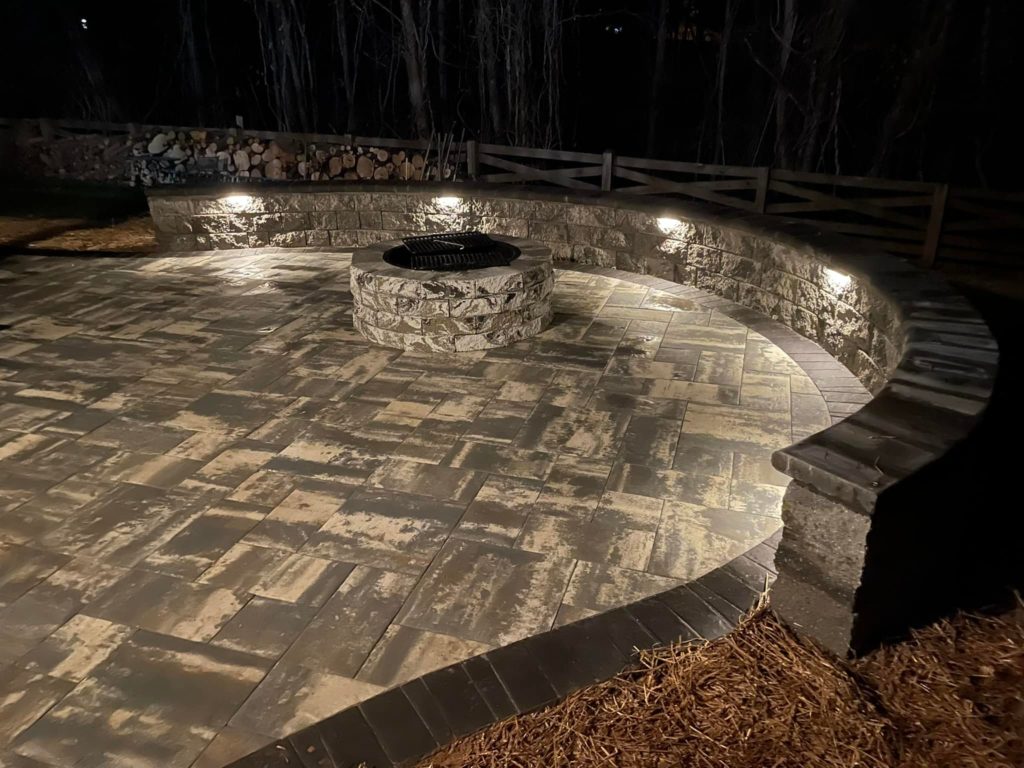 Circular patio with firepit and lighted retaining wall