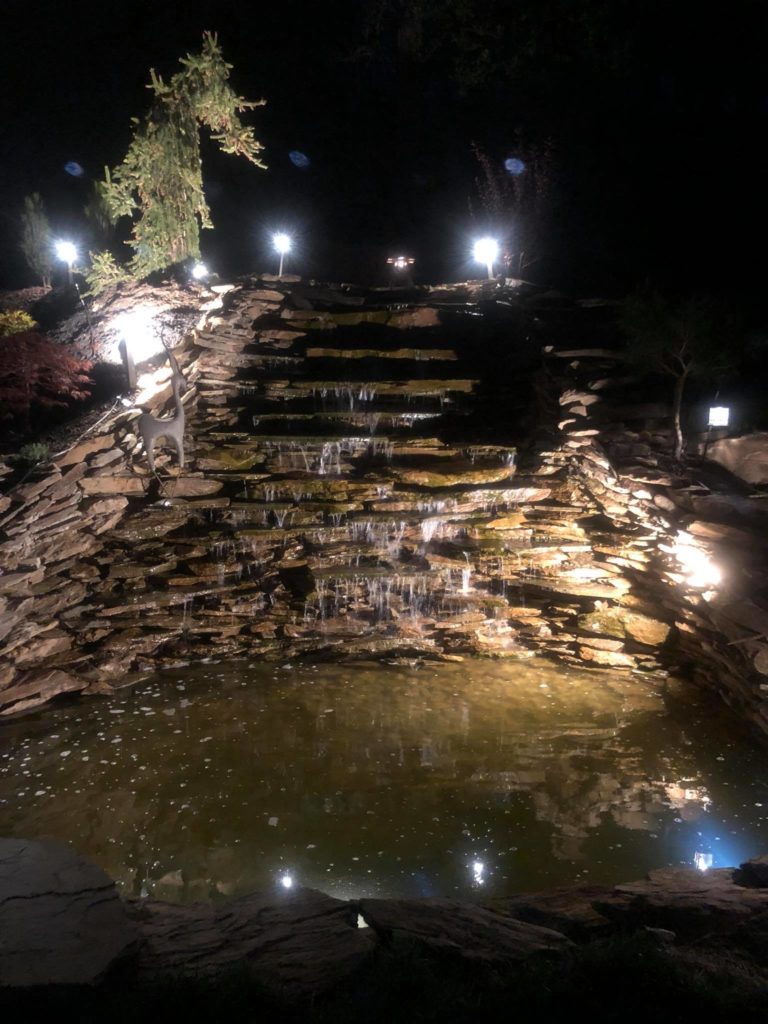 Night scene with lighted Waterfall with Pond